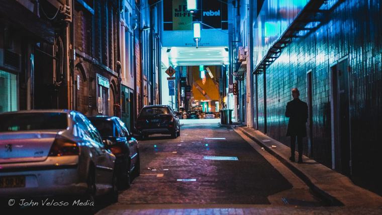 Quiet laneway washed in blue and teal light