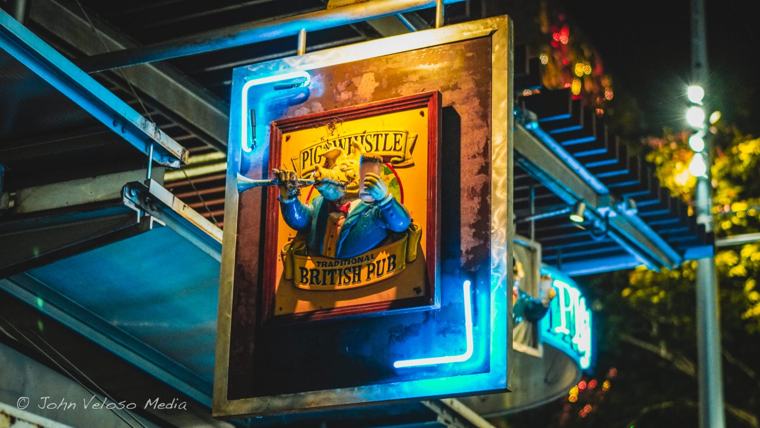 Neon-framed pub sign glowing at night